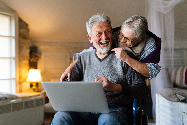 Junges Paar recherchiert am Laptop zum Thema Treppenlift